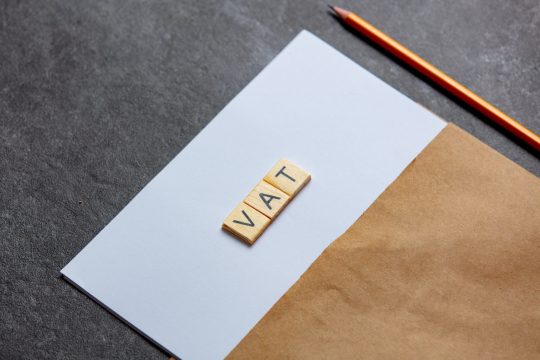 paper-sheet-and-pencil-with-vat-letters-on-gray-ba-2022-01-10-22-14-56-utc-min